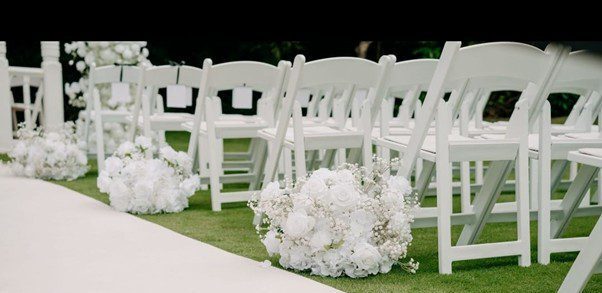 Wedding chairs decorated with flowers hired from The Floral Hire